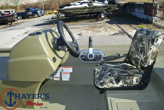 Slide: The Image of 2024 Tracker GRIZZLY® 1754 SC boat interior with camo seat and steering console. - 13