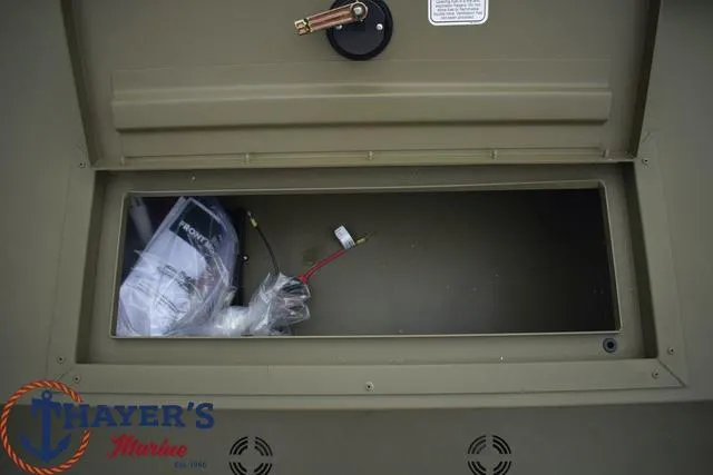 Slide: The Image of 2024 Tracker GRIZZLY® 1860 CC storage compartment with Thayer's Marine logo. - 10