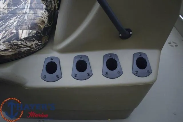 Slide: The Image of 2024 Tracker GRIZZLY® 1860 CC boat console with rod holders, Thayer's Marine logo. - 13