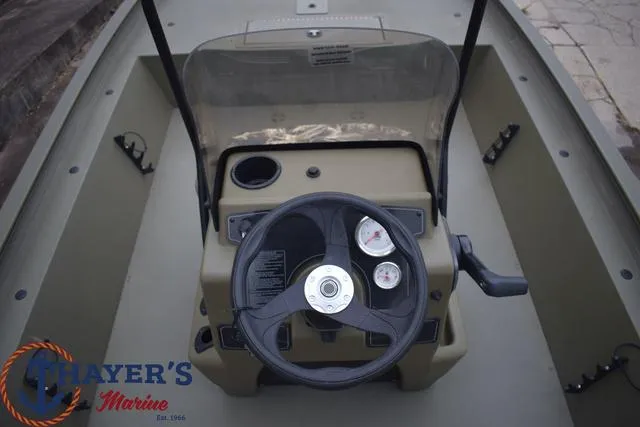 Slide: The Image of 2024 Tracker GRIZZLY® 1860 CC boat console with steering wheel and gauges. - 9