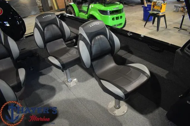 Slide: The Image of 2024 Lund 1875 Impact XS Sport boat interior with black and gray seats. - 15