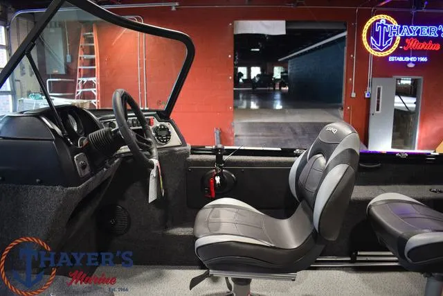 Slide: The Image of 2024 Lund 1875 Impact XS Sport boat interior at Thayer's Marine showroom. - 18