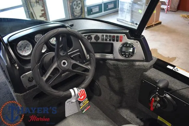 Slide: The Image of 2024 Lund 1875 Impact XS Sport boat dashboard and steering wheel. - 19
