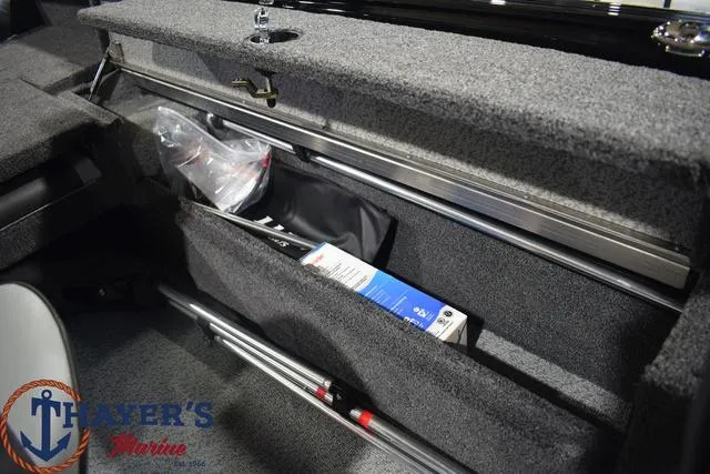 Slide: The Image of 2024 Lund 1875 Impact XS Sport storage compartment with fishing gear and accessories. - 24