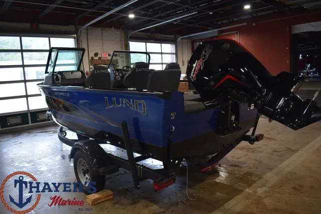 Slide: The Image of 2024 Lund 1875 Impact XS Sport boat in a showroom at Thayer's Marine. - 27