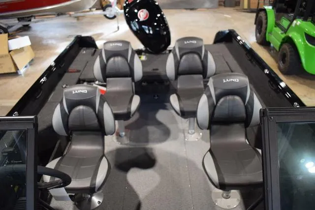 Slide: The Image of 2024 Lund 1875 Impact XS Sport boat interior with four grey seats. - 31