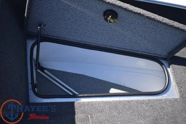 Slide: The Image of 2024 Lund 1675 Adventure Sport storage compartment with Thayer's Marine logo. - 11