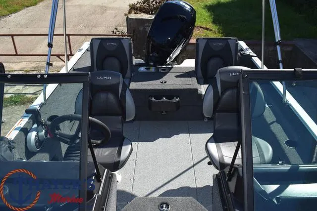 Slide: The Image of 2024 Lund 1675 Adventure Sport boat interior with seating and console. - 17