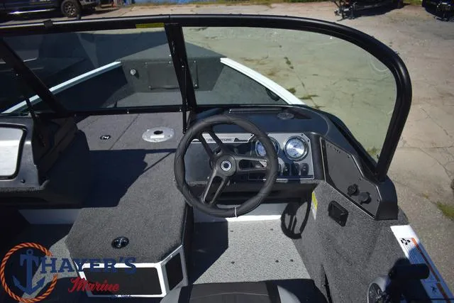 Slide: The Image of 2024 Lund 1675 Adventure Sport boat interior with steering wheel and dashboard. - 7