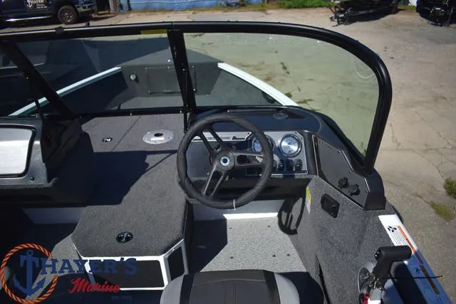 Slide: The Image of 2024 Lund 1675 Adventure Sport boat interior with steering wheel and dashboard. - 8