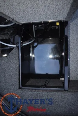 Slide: The Image of 2024 Lund 1650 Angler Sport interior compartment with Thayer's Marine logo. - 13
