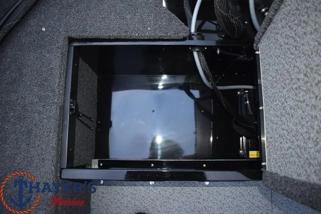 Slide: The Image of 2024 Lund 1650 Angler Sport storage compartment with carpeted interior. - 14
