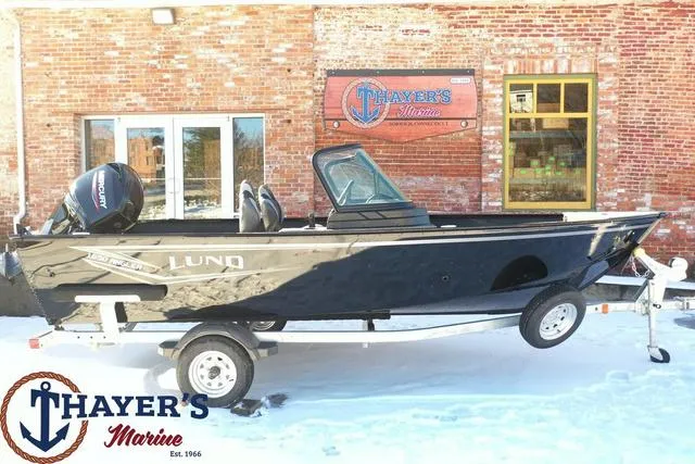 Slide: The Image of 2024 Lund 1650 Angler Sport boat on trailer outside Thayer's Marine. - 19