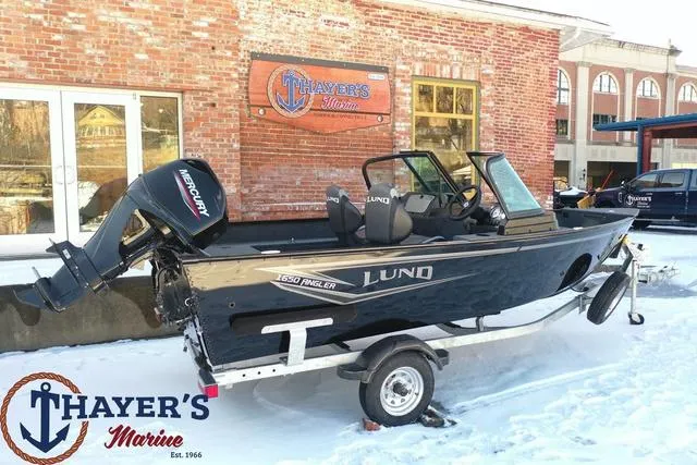 Slide: The Image of 2024 Lund 1650 Angler Sport boat on trailer at Thayer's Marine dealership. - 21