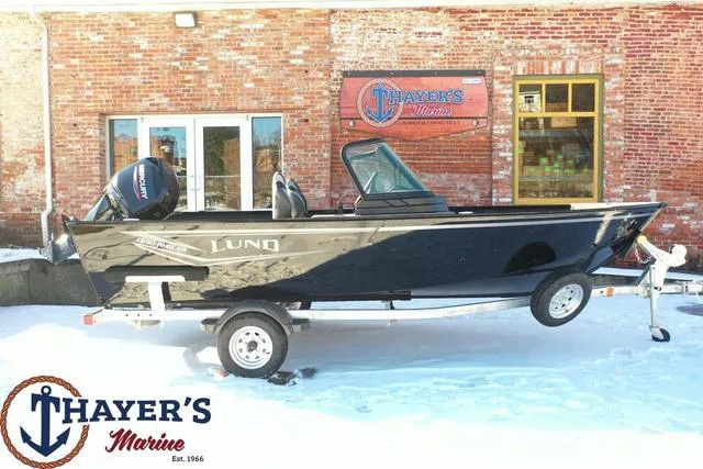 Slide: The Image of 2024 Lund 1650 Angler Sport boat on trailer at Thayer's Marine dealership. - 22
