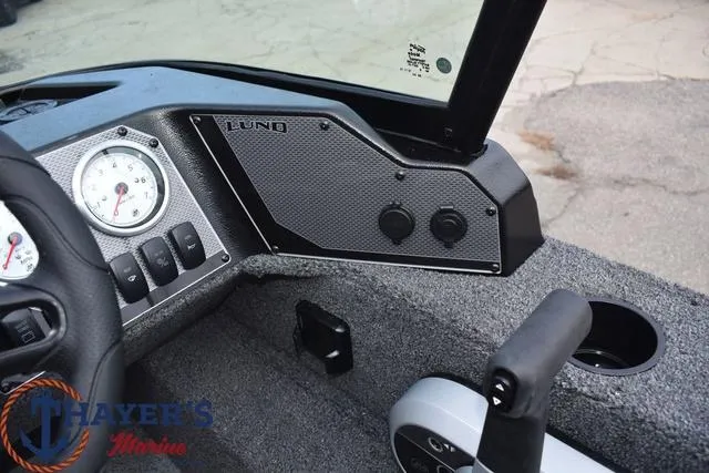 Slide: The Image of 2024 Lund 1650 Angler Sport boat dashboard with gauges and controls. - 21