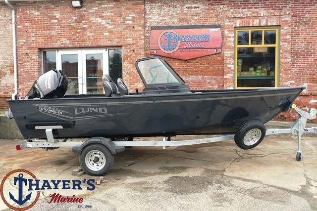 Slide: The Image of 2024 Lund 1650 Angler Sport boat on trailer at Thayer's Marine. - 25