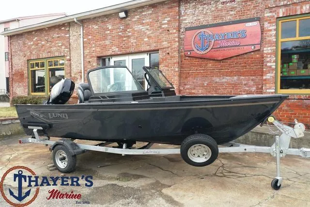Slide: The Image of 2024 Lund 1650 Angler Sport boat on trailer at Thayer's Marine dealership. - 26