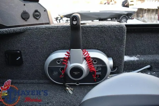Slide: The Image of Control panel of a 2024 Lund 1650 Rebel XL Sport boat with throttle and ignition. - 16