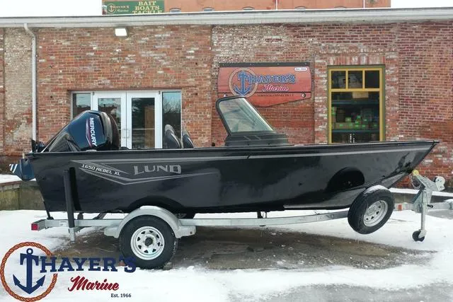 Slide: The Image of 2024 Lund 1650 Rebel XL Sport boat on trailer outside Thayer's Marine. - 17