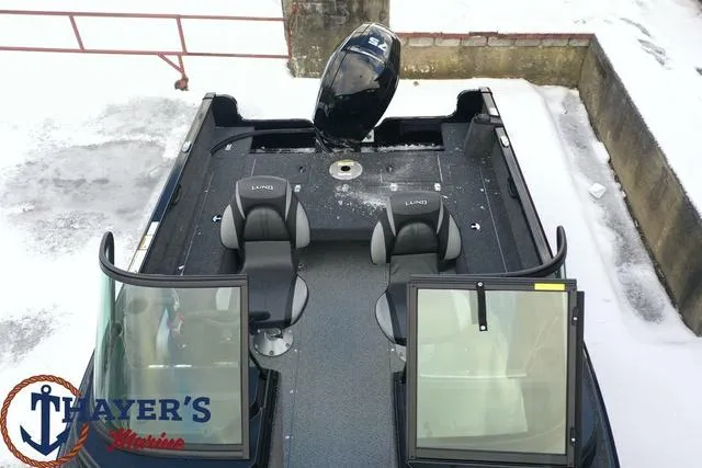 Slide: The Image of 2024 Lund 1650 Rebel XL Sport boat with dual seats and open windshield. - 21