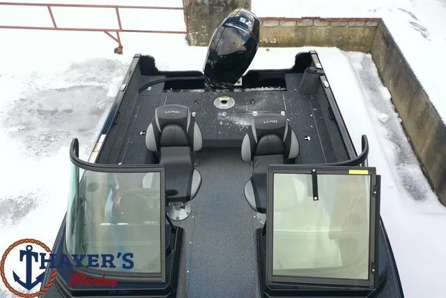 Slide: The Image of 2024 Lund 1650 Rebel XL Sport boat with dual seats and windshield. - 22