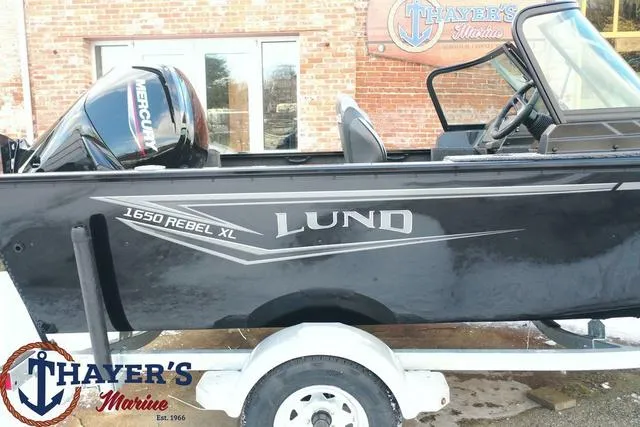 Slide: The Image of 2024 Lund 1650 Rebel XL Sport boat on trailer at Thayer's Marine. - 25