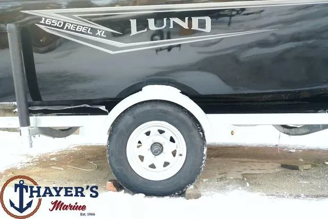 Slide: The Image of 2024 Lund 1650 Rebel XL Sport boat on trailer at Thayer's Marine. - 26