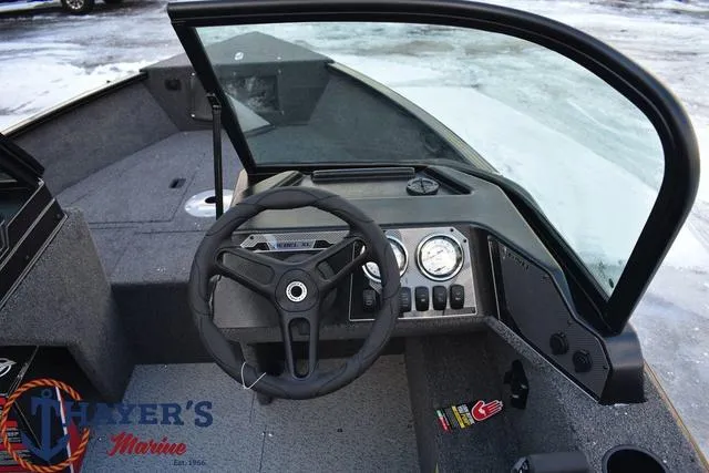 Slide: The Image of 2024 Lund 1650 Rebel XL Sport boat dashboard and steering wheel. - 4