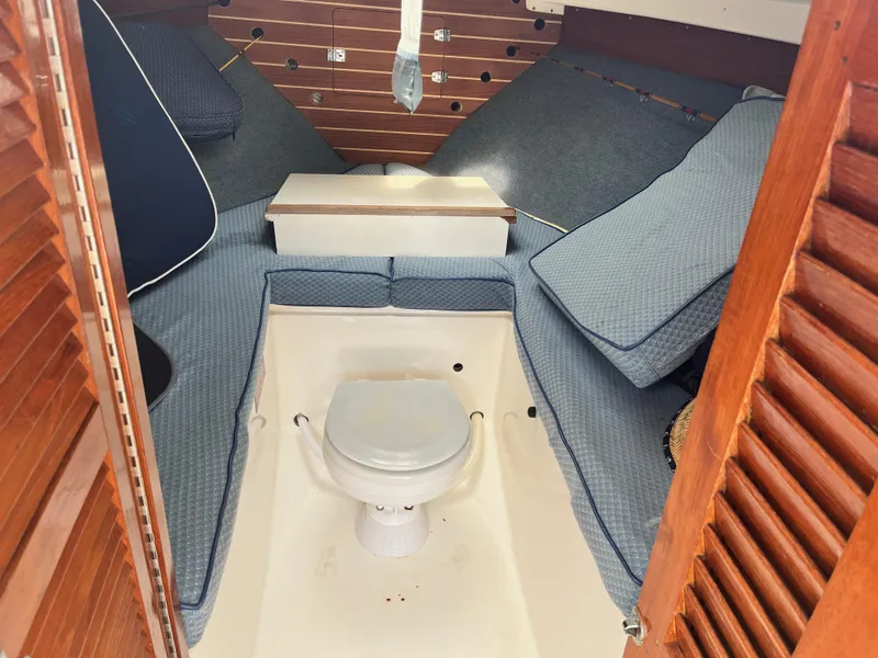 Slide: The Image of 1977 Bertram 26 Moppie cabin interior with cushions and marine toilet. - 17