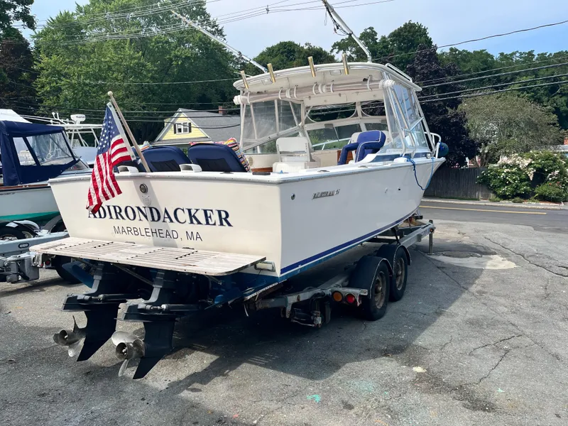 Slide: The Image of 1977 Bertram 26 Moppie boat on trailer, named "ADIRONDACKER," with American flag, Marblehead, MA. - 2