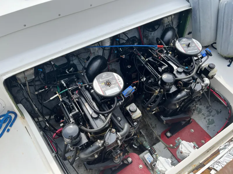 Slide: The Image of Engine compartment of a 1977 Bertram 26 Moppie boat, featuring dual engines. - 24