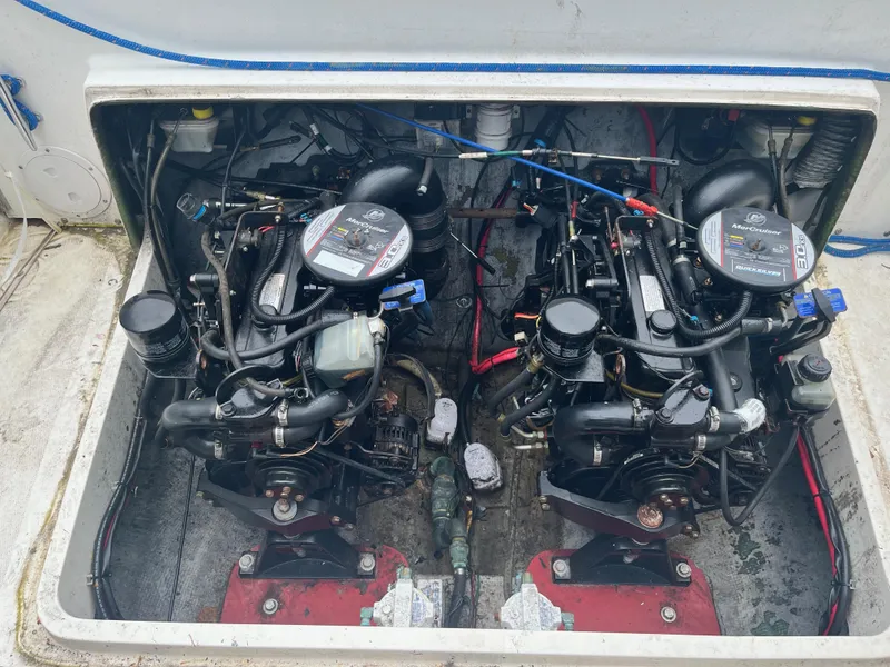 Slide: The Image of Twin engines in a 1977 Bertram 26 Moppie boat, showcasing detailed mechanical components. - 25