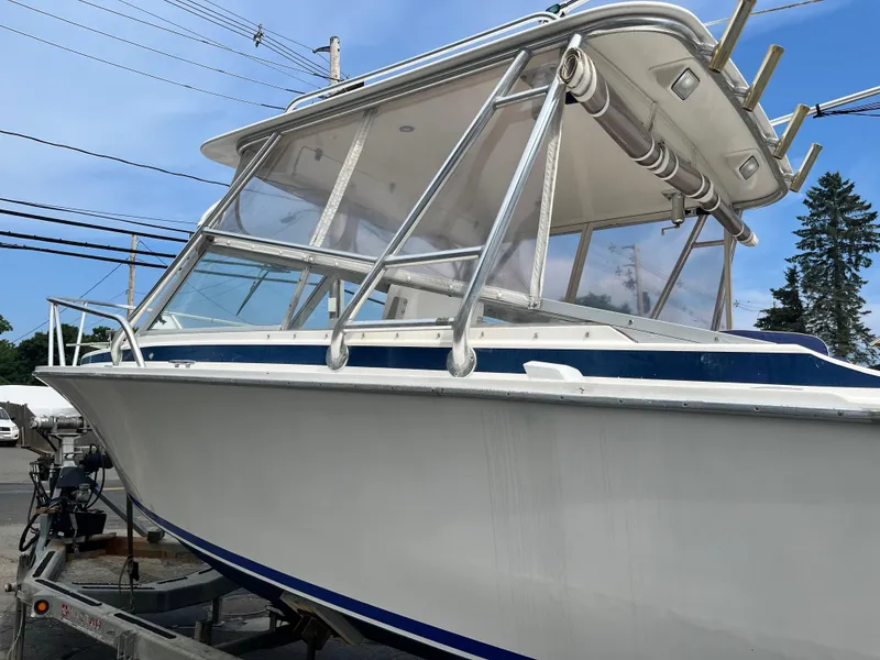 Slide: The Image of 1977 Bertram 26 Moppie boat on trailer, featuring sleek design and sturdy structure. - 26