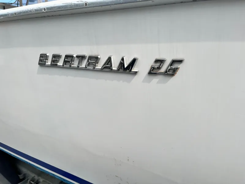 Slide: The Image of 1977 Bertram 26 Moppie boat with chrome lettering on white hull. - 28
