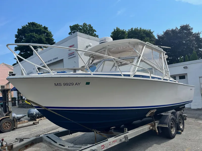 Slide: The Image of 1977 Bertram 26 Moppie boat on trailer, parked outdoors. - 4