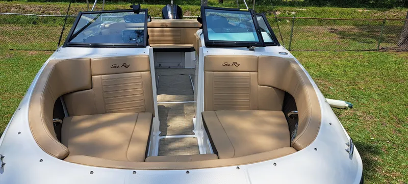 Slide: The Image of 2019 Sea Ray SPX 230 OB boat with tan seating and open deck. - 2