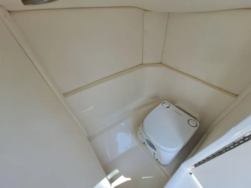 Slide: The Image of 2019 Sea Ray SPX 230 OB boat interior with compact toilet. - 21