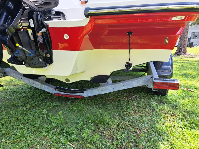 Slide: The Image of 2019 Sea Ray SPX 230 OB boat on trailer, rear view showing outboard motor and hull. - 42