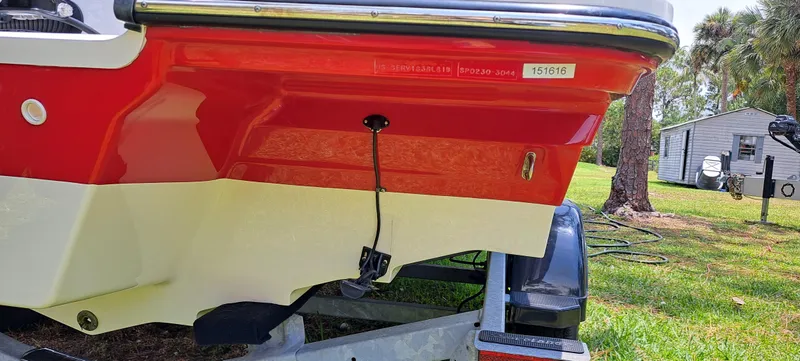 Slide: The Image of 2019 Sea Ray SPX 230 OB boat on trailer, red and white hull, rear view. - 44