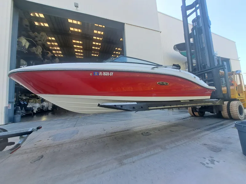 Slide: The Image of 2019 Sea Ray SPX 230 OB boat in red and white, lifted by a forklift. - 5