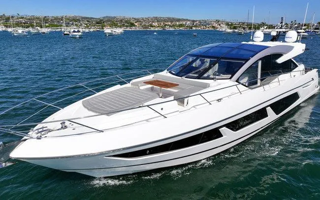 Slide: The Image of 2018 Sunseeker Predator 74 yacht cruising on a sunny day in a scenic harbor. - 3