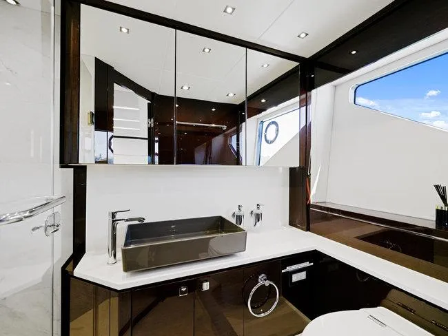 Slide: The Image of Luxurious bathroom in 2018 Sunseeker Predator 74 yacht with modern fixtures and large mirror. - 33