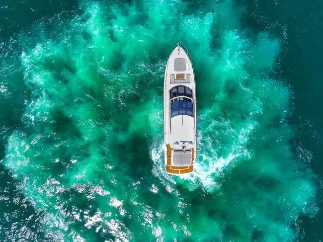 Slide: The Image of Sunseeker Predator 74 yacht cruising in turquoise waters, aerial view, 2018 model. - 4