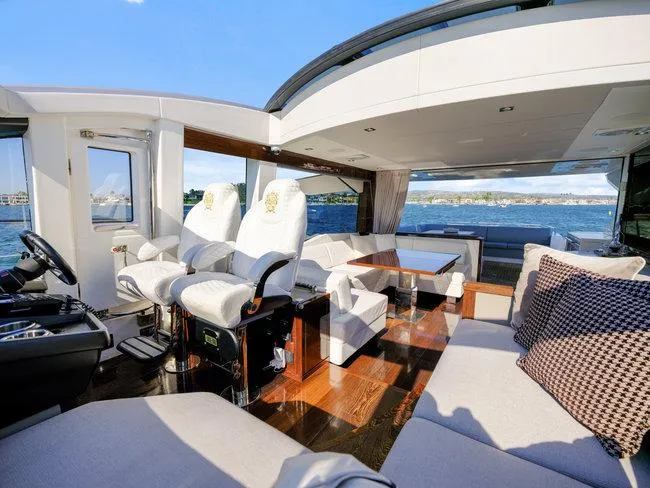 Slide: The Image of Luxurious interior of 2018 Sunseeker Predator 74 yacht with plush seating and scenic ocean view. - 46