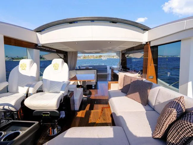 Slide: The Image of Luxurious 2018 Sunseeker Predator 74 yacht interior with plush seating and ocean view. - 49
