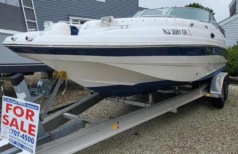The Image of 2002 Chaparral Sunesta 233 boat for sale on trailer, white and blue exterior. - 0