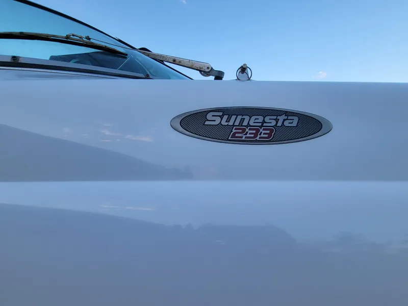 Slide: The Image of 2002 Chaparral Sunesta 233 boat emblem against a clear blue sky. - 10