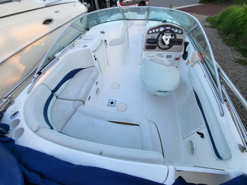 Slide: The Image of 2002 Chaparral Sunesta 233 boat interior with seating and steering console. - 19