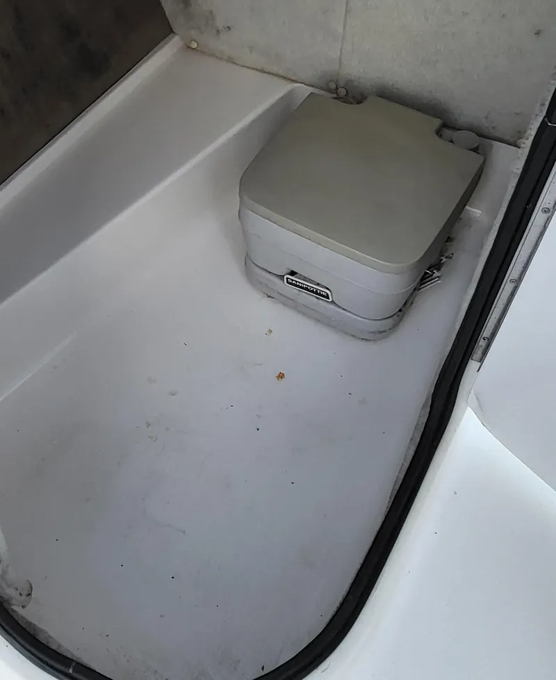 Slide: The Image of 2002 Chaparral Sunesta 233 boat interior with portable toilet. - 21